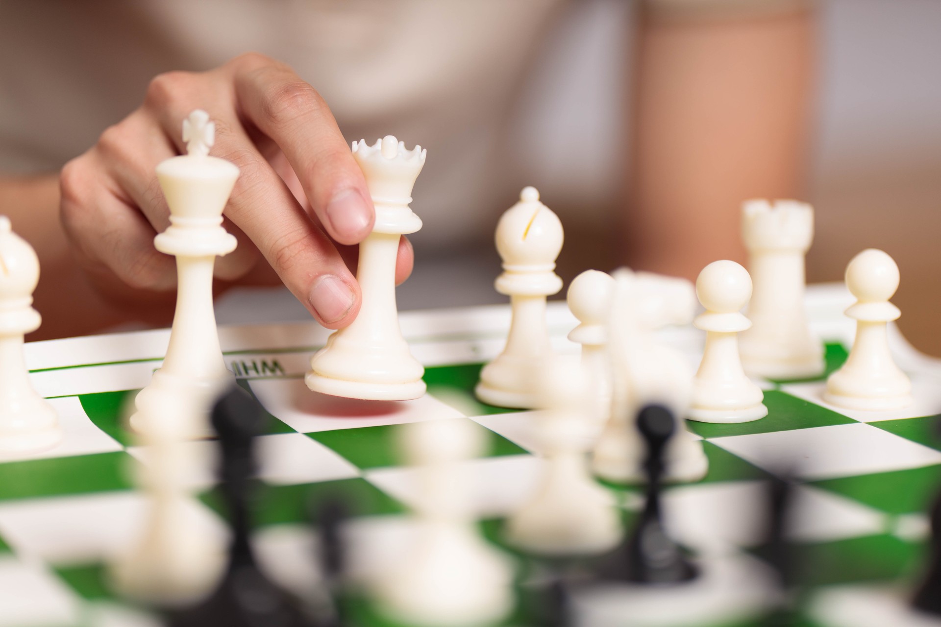 A person moving pieces on a chessboard